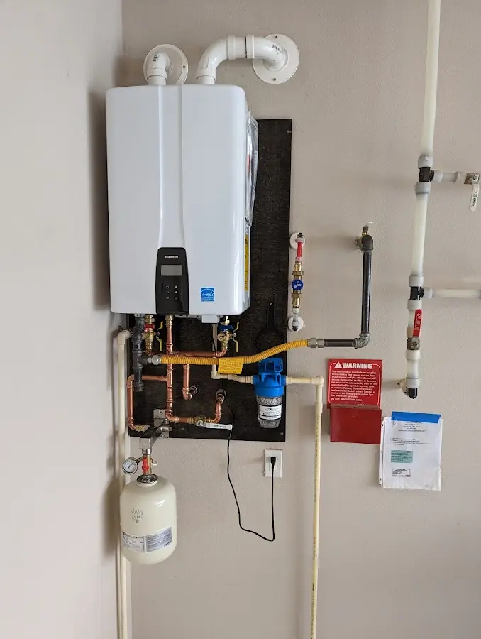 Professional plumber installing copper piping in a Talent home